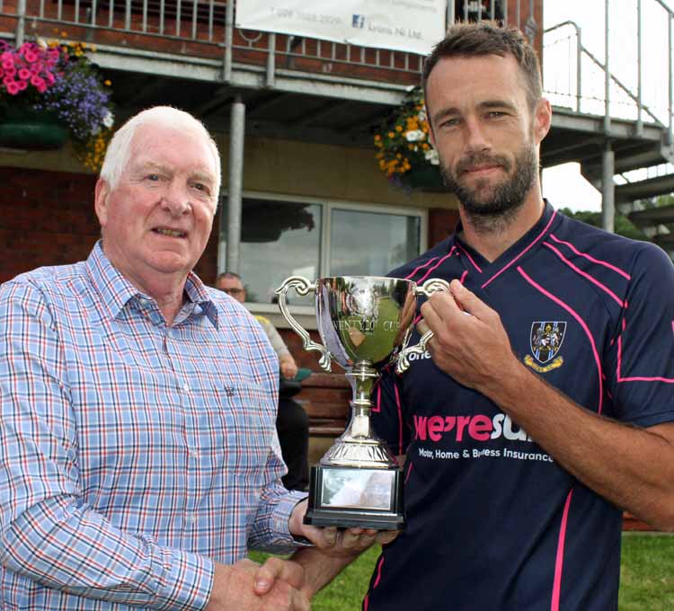 Tommy Anderson presents Lagan Valley Steels trophy to Nigel Jones of CIYMS